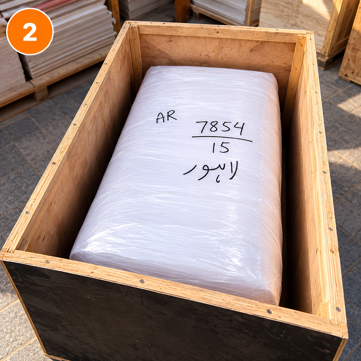 Furniture cargo protected with plastic wrapping inside a wooden shipping crate in Dubai